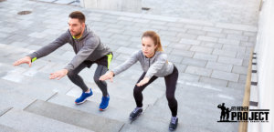 couple doing squats on city street stairs workout tips for men