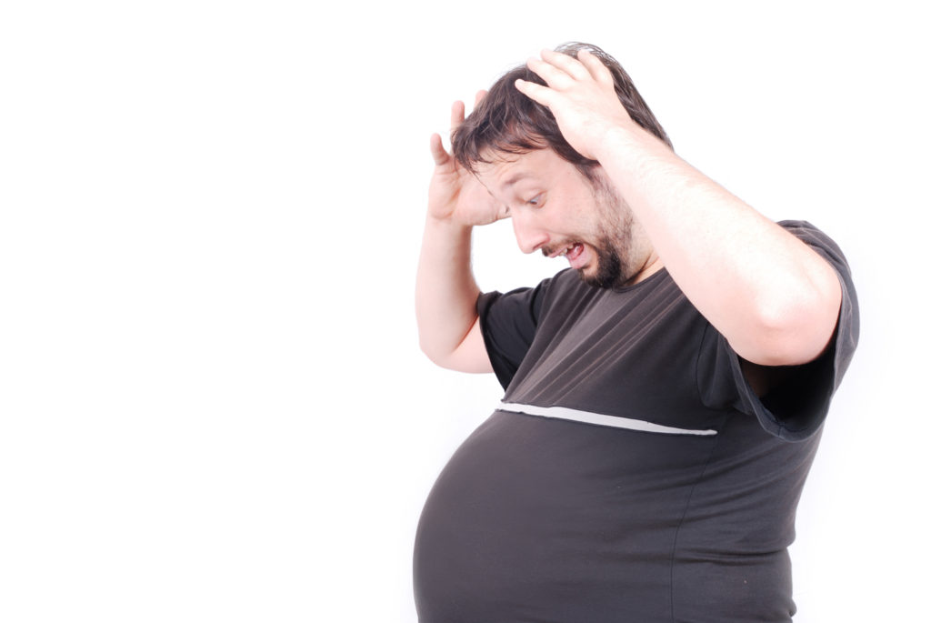 man looking at belly how to lose 20 lbs