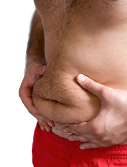 man pinching the fat on his stomach get rid of belly fat
