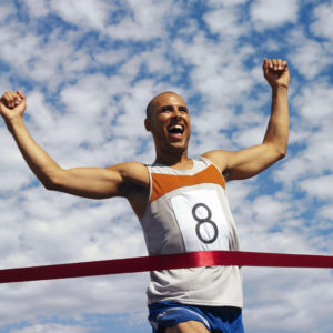 man crossing finish line