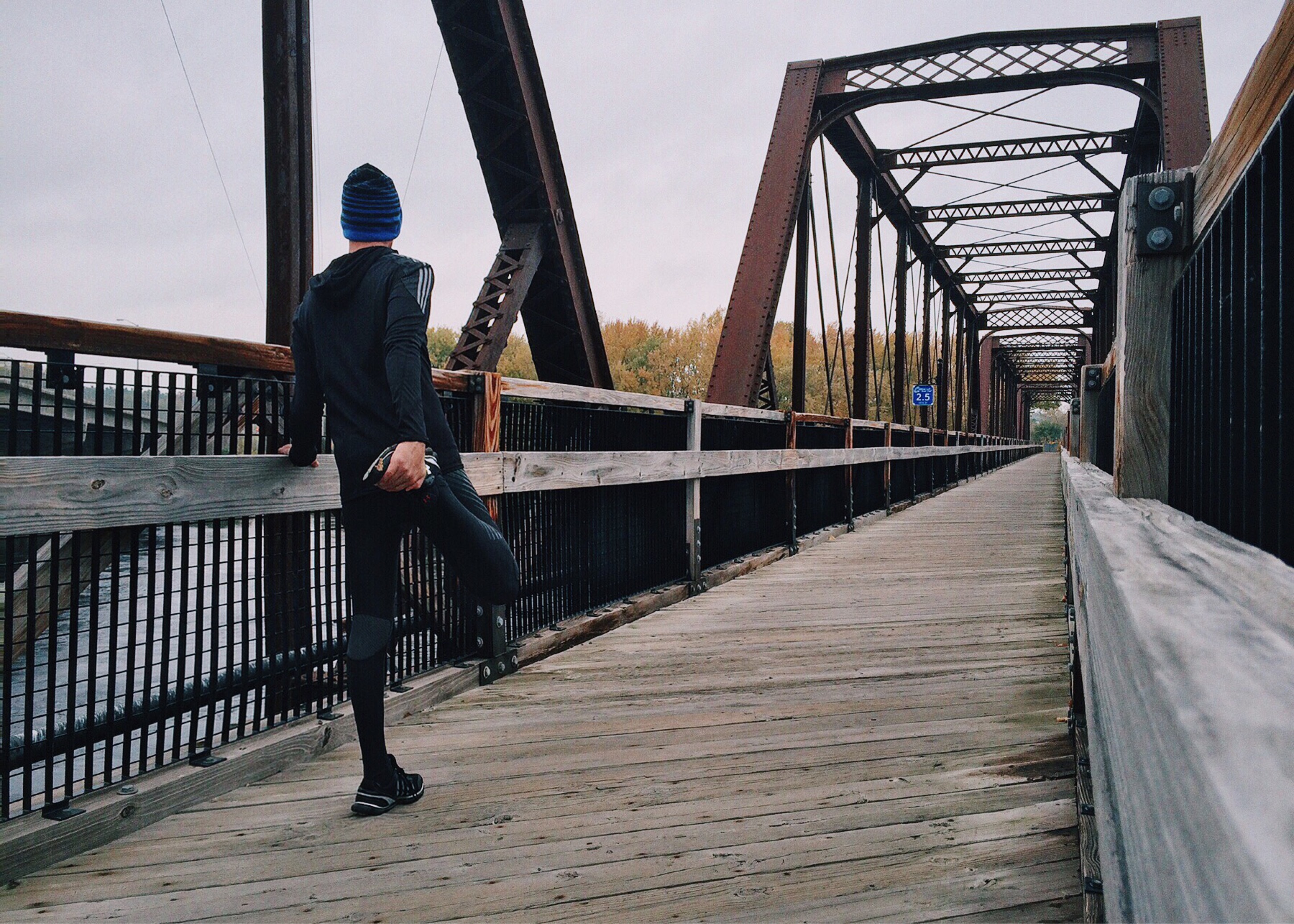 man stretching before running for body management