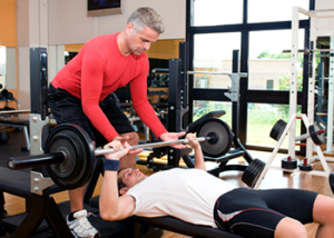 spotter helping man workout tips for men