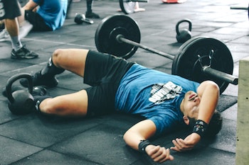 measuring workout intensity man passed on floor after working out