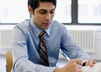 man writing with in office body measurements for men