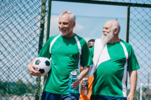 older men playing soccer