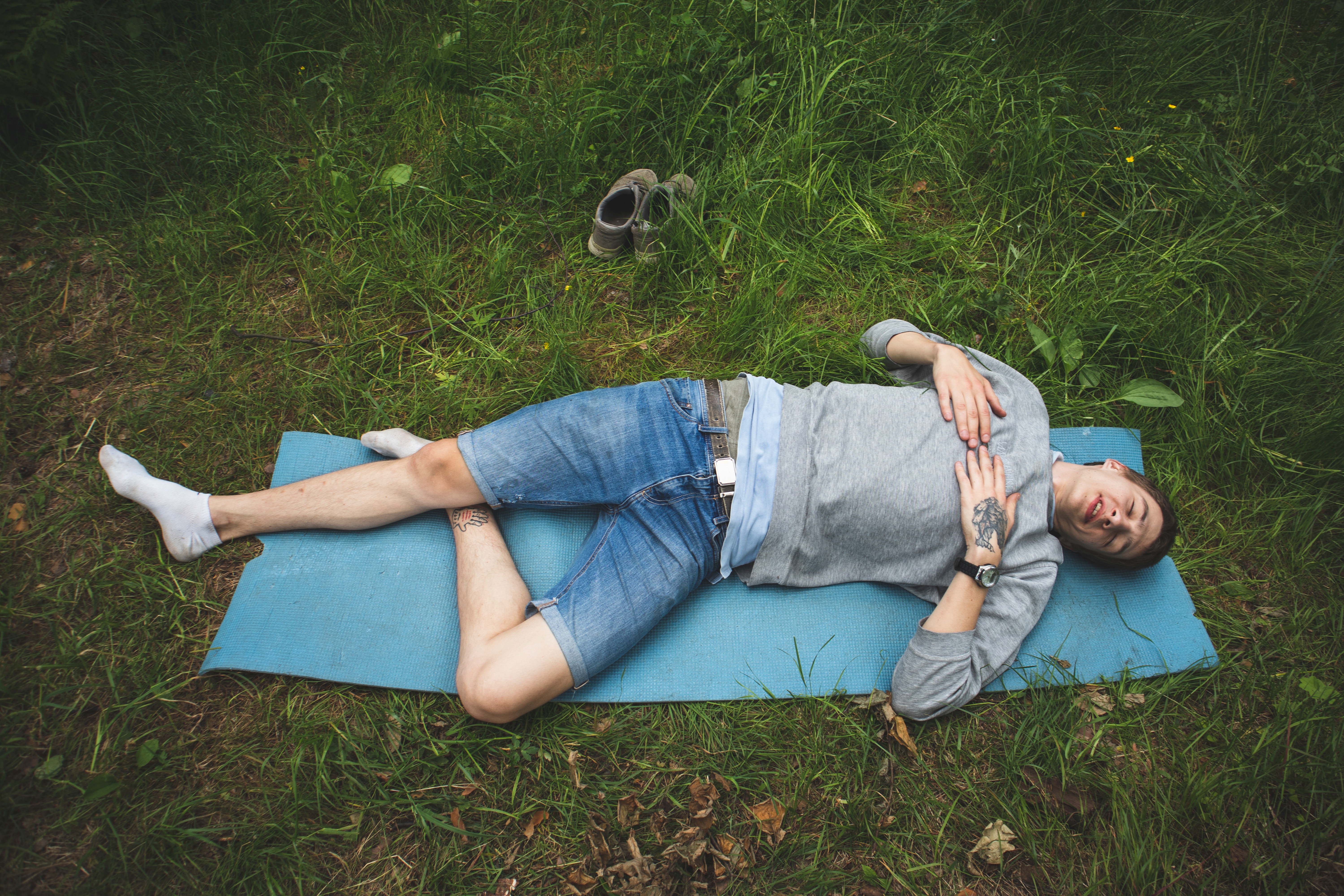 man laying on yoga mat weight loss yoga for men