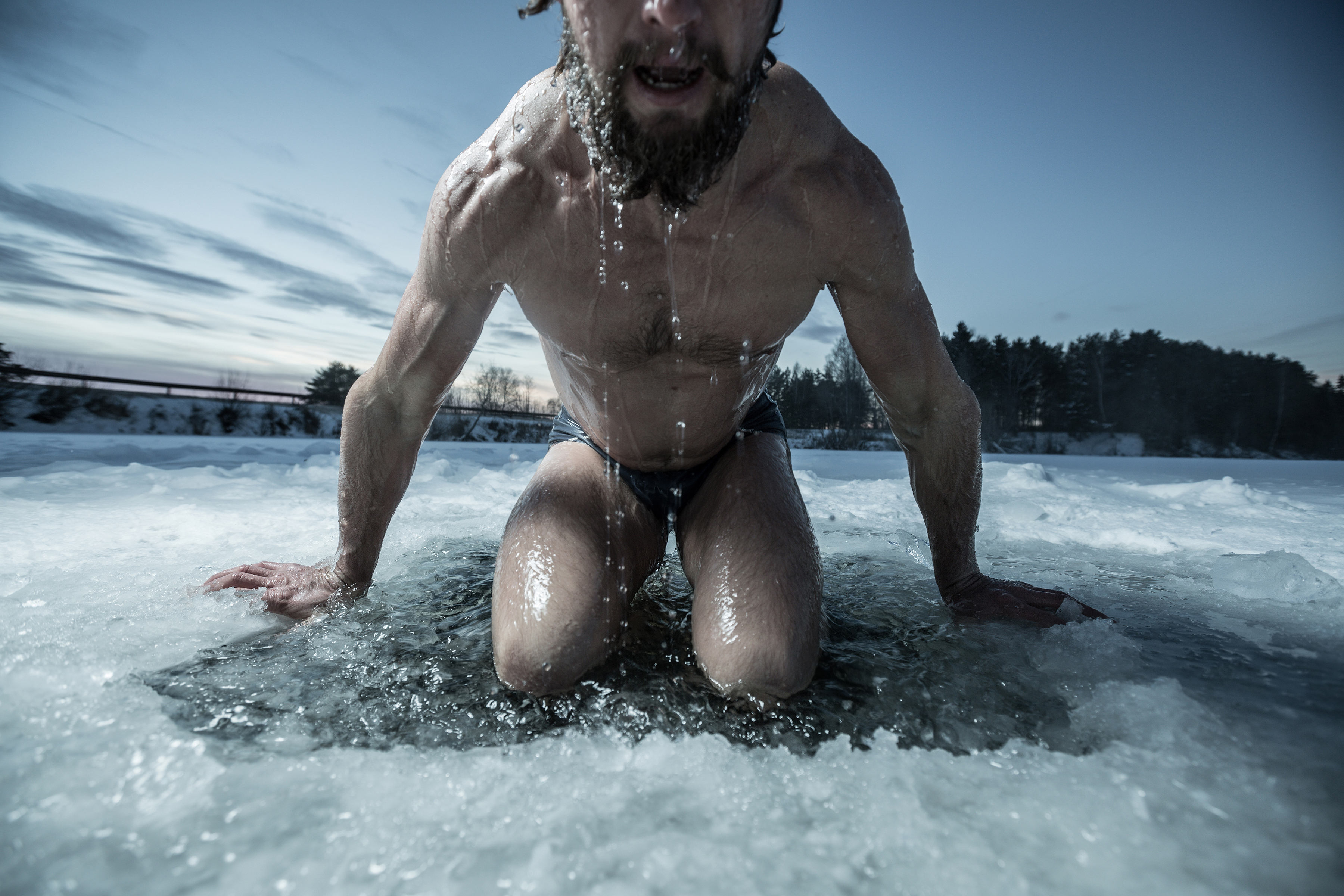 凍った湖の冬のトレーニングでジャンプする男