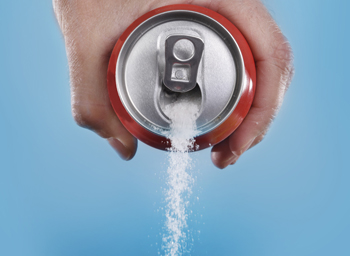 hand holding soda can pouring a crazy amount of sugar in metaphor of sugar content of a refresh drink isolated on blue background in healthy lifestyle improves mental clarity